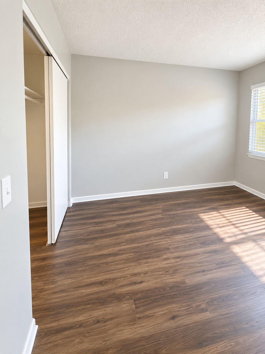 Bedroom with dark plank flooring