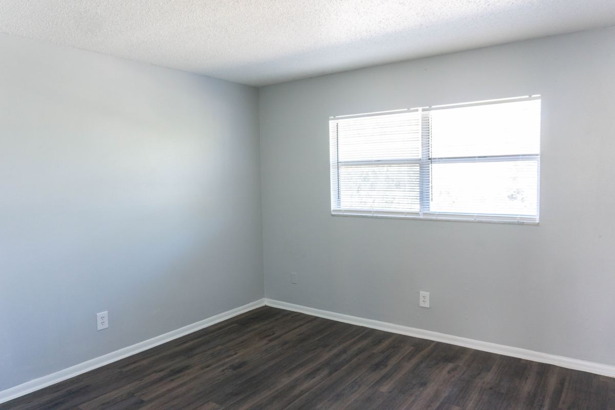 Bedroom with dark plank flooring